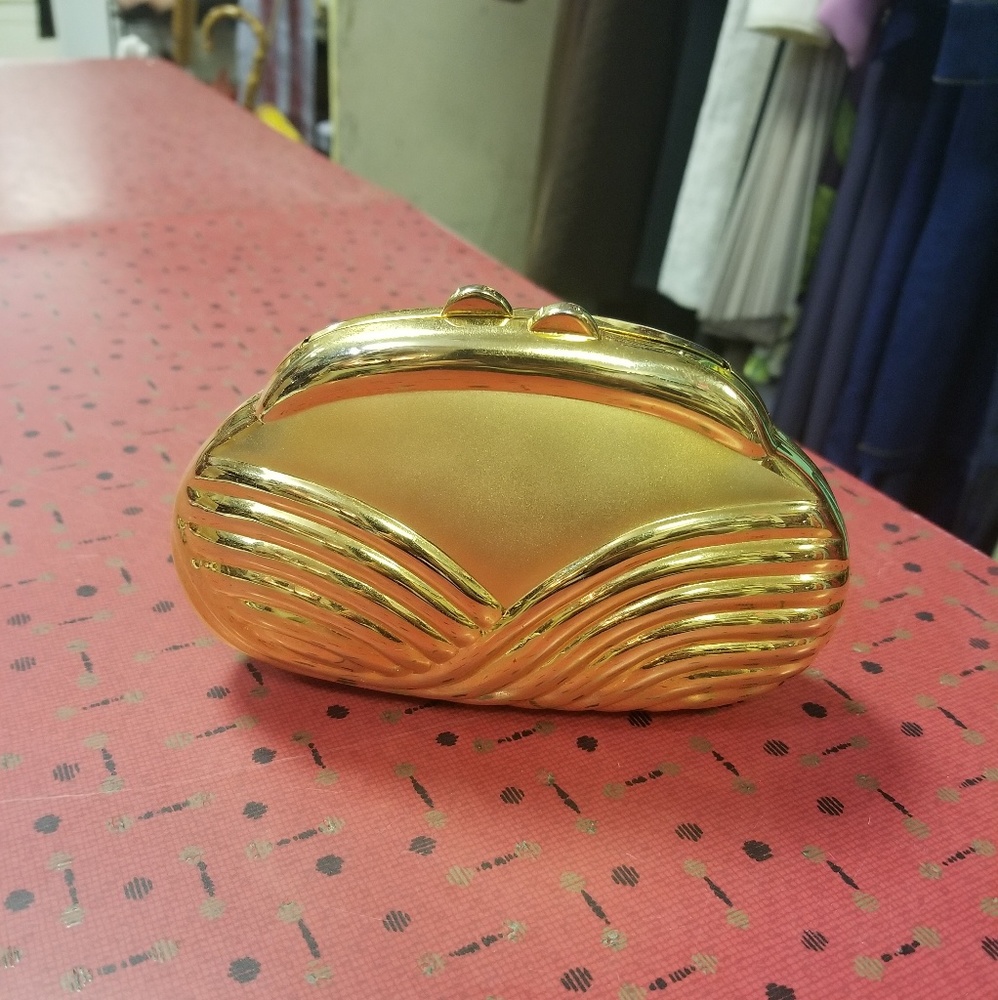 Gold hard shell clutch.